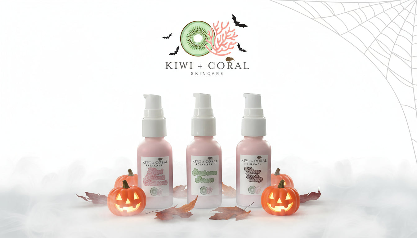 Kiwi and Coral Skincare Everyday Glow Trio — Kiwi Splash Cleanser, Sunbeam Serum, and Glow Whip Moisturizer in pink glass bottles with white pumps, displayed with small jack-o’-lantern pumpkins, autumn leaves, and light fog under the Kiwi and Coral logo. Clean, vegan teen skincare set for glowing skin with a fun Halloween theme.