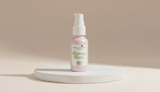 Pink glass bottle with a white pump labeled “Kiwi & Coral Skincare Sunbeam Serum” on a white background. Highlights: brightening facial serum in eco-friendly glass packaging, designed to balance and smooth teen skin with lightweight, nourishing ingredients.